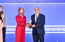 Minister of Housing, Land and Urban Development Ali Haidar Ahmed presenting an award to a student at the High Achievers Award Ceremony 2022-2023 today. -- Photo: Nishan Ali / Mihaaru News