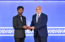 Minister of Housing, Land and Urban Development Ali Haidar Ahmed presenting an award to a student at the High Achievers Award Ceremony 2022-2023 today. -- Photo: Nishan Ali / Mihaaru News