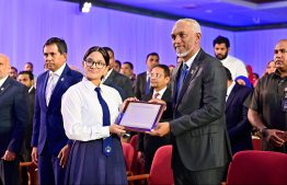 President Dr Mohamed Muizzu presenting a plaque of memorandum to a student at the High Achievers Award Ceremony 2022-2023 today. -- Photo: Nishan Ali / Mihaaru News