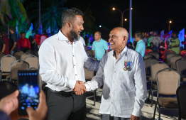 Retired Magistrate Idhrees Adam and MP of North Hithadhoo Constituency Mohamed Sinan exchanging a handshake during the special ceremony held at Haa Alif atoll Uligan to inaugurate the headquarters of the Uthuru (North) ISPS Gateway Project. -- Photo: Nishan Ali / Mihaaru News