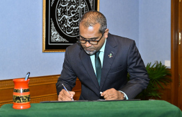 Dr Abdulla Khaleel signs his letter of appointment -- Photo: President's Office