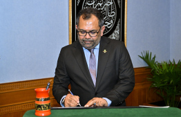 Moosa Zameer signs his letter of appointment -- Photo: President's Office