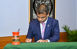 Abdulla Nazim Ibrahim signs his letter of appointment -- Photo: President's Office