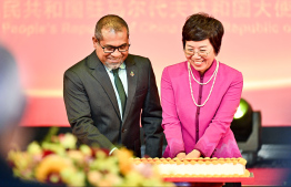 Ambassador Wang Lixin and Minister of Foreign Affairs Dr Abdulla Khaleel cutting the special cake during China's 75th National Day Reception -- Photo: Fayaz Moosa