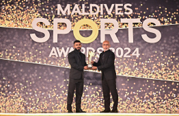 Sports Minister handing over the best bodybuilder award to Azneen Rashad during the Maldives Sports Awards -- Photo: Fayaz Moosa | Mihaaru