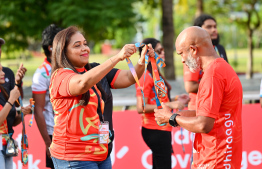 A participant of the Dhiraagu Maldives Road Race receiving their medal after completing the race -- Photo: Nishan Ali |Mihaaru