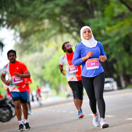 A participant of the Dhiraagu Maldives Road Race receiving their medal after completing the race -- Photo: Nishan Ali |Mihaaru