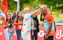 A participant of the Dhiraagu Maldives Road Race receiving their medal after completing the race -- Photo: Nishan Ali |Mihaaru