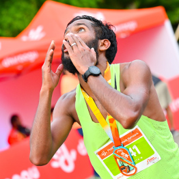 A participant of the 10 kilometre Dhiraagu Maldives Road Race 2024 celebrating after the race -- Photo: Nishan Ali | MIhaaru