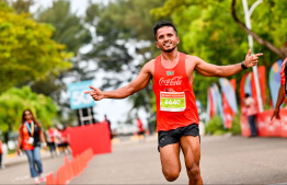 A participant of the Dhiraagu Maldives Road Race celebrating after their run -- Photo: Ali Nishan | Mihaaru