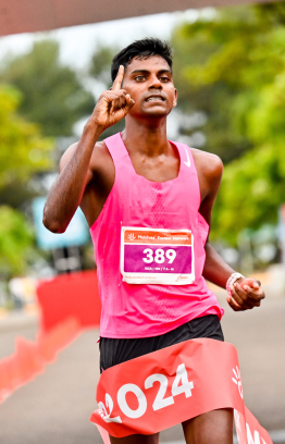 Local runner Riza celebrating after completing his race at the Dhiraagu Maldives Road Race 2024 -- Photo: Nishan Ali | Mihaaru