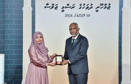 President Dr. Mohamed Muizzu conferring awards to high achievers in their respective fields -- Photo: President's Office