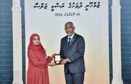 President Dr. Mohamed Muizzu conferring awards to high achievers in their respective fields -- Photo: President's Office