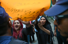 PNC and MDP activists gather outside parliament -- Photo: Nishan Ali