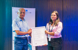 AMDC Chairman Adam Naeem handing over certificate to department head -- Photo: AMDC