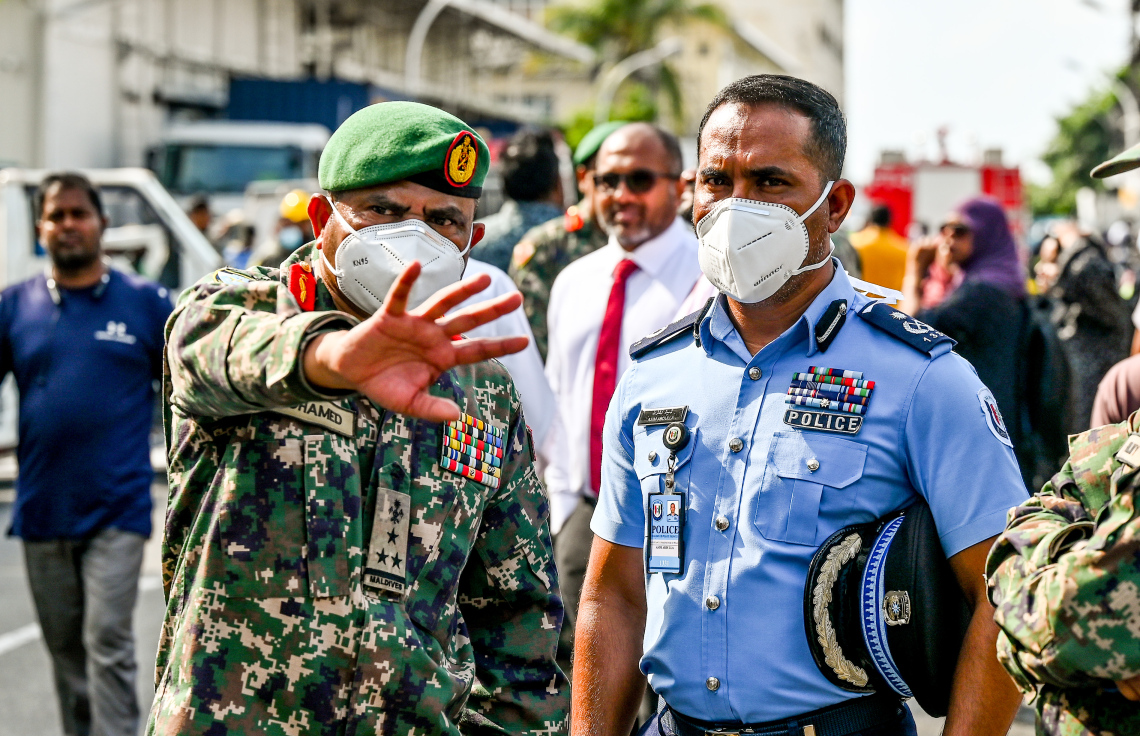 މ. ގްރީން ބިލްޑިންގައި ރޯވުމާ ގުޅިގެން އަލިފާން ނިއްވާލުމުގެ މަސައްކަތް ބައްލަވާލައްވަން ސިފައިންނާއި ފުލުހުންގެ އިސްވެރިޔަކު އެ ސަރަހައްދުގައި.-- ފޮޓޯ: ނިޝާން އަލީ | މިހާރު