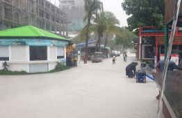 MNDF officers begin efforts to drain water -- Photo: MNDF