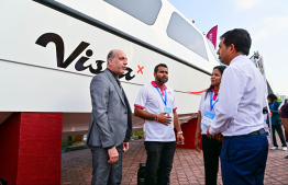 Economic Minister Saeed talks to representatives of a speedboat company at the Maldives Marine Expo 2025 -- Photo: Fayaz Moosa | Mihaaru