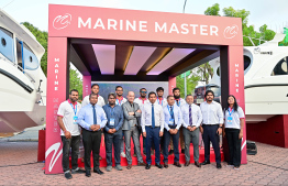 Economic Minister Saeed and Fisheries Minister Shiyam take a group photo with Marine Masters at the Maldives Marine Expo 2025 -- Photo: Fayaz Moosa | Mihaaru