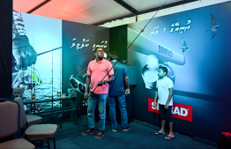 A visitor checking out a fishing rod at one of the stalls -- Photo: Fayaz Moosa | Mihaaru