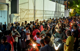 People in queue to collect their tuna can cases -- Photo: Nishan Ali | Mihaaru