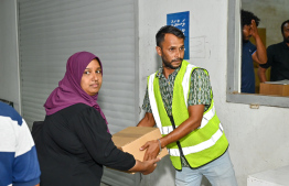 Fish can cases being distributed in the Malé area ahead of Ramadan -- Photo: Nishan Ali | Mihaaru