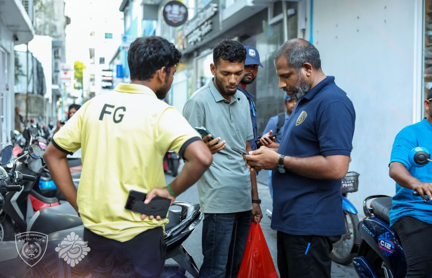 ގަވާއިދާ ހިލާފަށް އުޅޭ ބިދޭސީން ހުއްޓުވުމަށް އިއްޔެ ކުރިއަށްގެންދިޔަ އޮޕަރޭޝަނުގައި ބިދޭސީންނާ ސުވާލު ކުރަނީ -- ފޮޓޯ: އިމިގްރޭޝަން