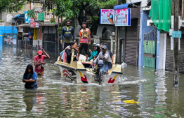 ތޫފާނުގެ ބޯ ވާރޭގައި ސްރީ ލަންކާގެ ކޮލަމްބޯގެ އަމްބާޓަލޭގައި ފެން ބޮޑުވެފައިވާ މަގެއްގައި މީހުންތަކެއް ލޯންޗަކަށް އަރުވައިގެން ގެންދަނީ. -- ފޮޓޯ: އޭއެފްޕީ