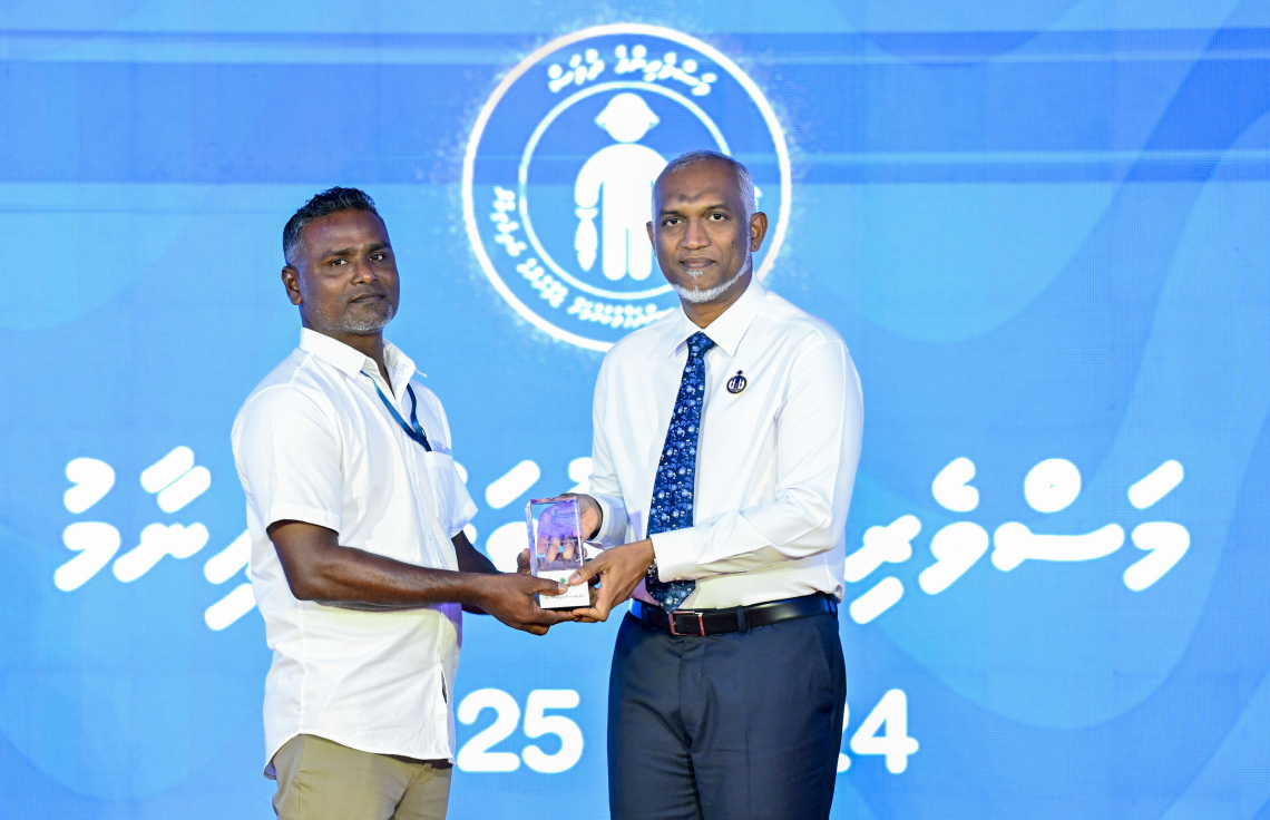 ރ. ދުވާފަރުގައި ރޭ ބޭއްވި މި އަހަރުގެ މަސްވެރިންގެ ދުވަހުގެ ރަސްމީ ޖަލްސާގައި ރައީސް ޑރ. މުހައްމަދު މުއިއްޒު މީހަކަށް ހަނދާނީ ފިލައެއް ދެއްވަނީ --- ފޮޓޯ: ރައީސް އޮފީސް